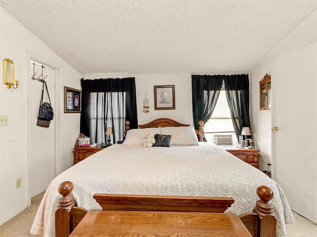 bedroom with light carpet, cooling unit, and a textured ceiling