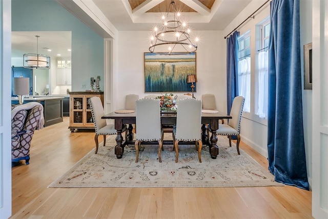 dining room with beamed ceiling, light wood-type flooring, and an inviting chandelier