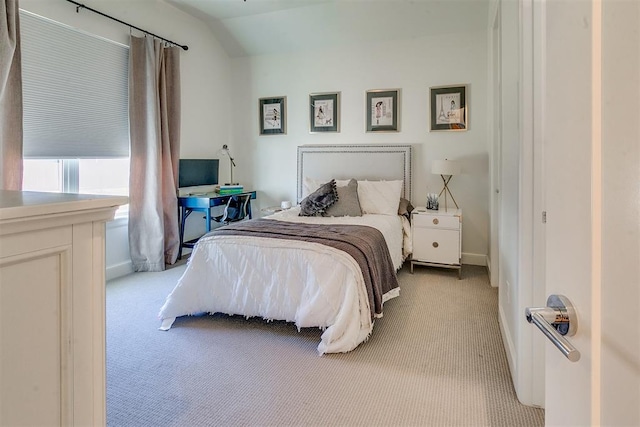 bedroom with light carpet and vaulted ceiling