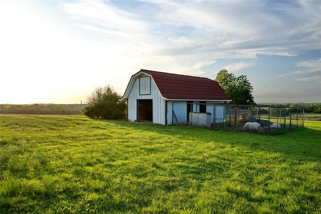 view of outbuilding with a rural view and a lawn