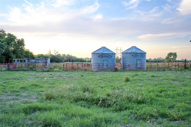 yard at dusk with a rural view