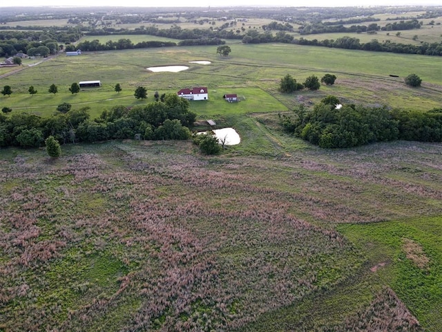 birds eye view of property with a rural view