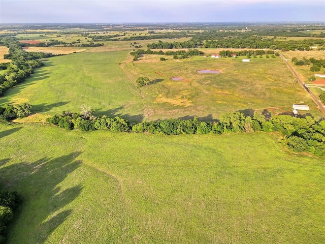 birds eye view of property with a rural view