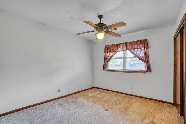 carpeted empty room with ceiling fan