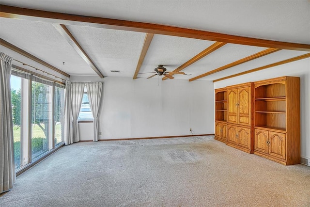 unfurnished living room featuring a textured ceiling, ceiling fan, beam ceiling, and light carpet