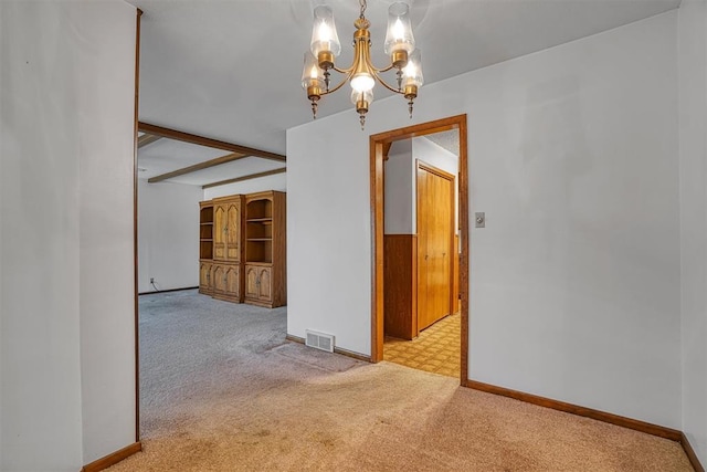 unfurnished dining area with beam ceiling, light colored carpet, and an inviting chandelier