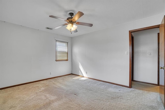 carpeted empty room featuring ceiling fan