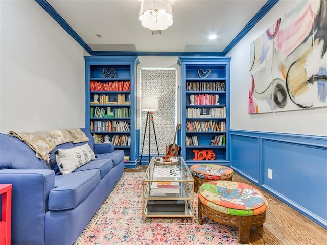 interior space featuring built in shelves, hardwood / wood-style floors, and ornamental molding