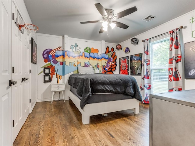 bedroom featuring wood-type flooring and ceiling fan