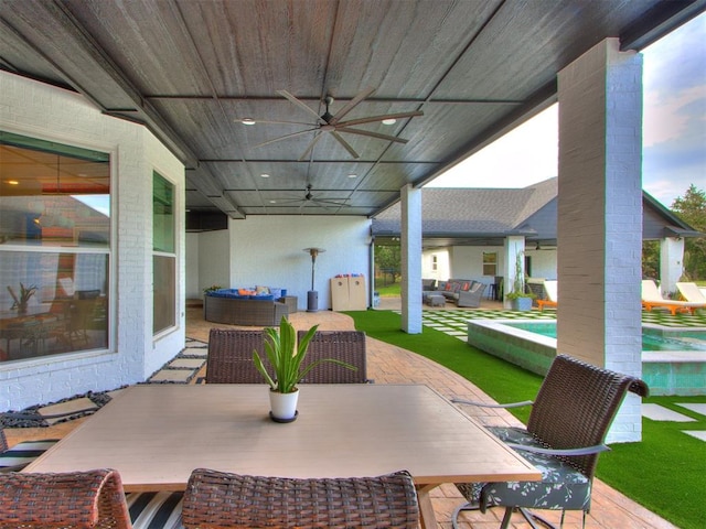 view of patio / terrace featuring outdoor lounge area, ceiling fan, and a swimming pool