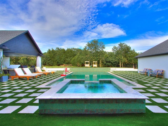 view of swimming pool with an in ground hot tub and a patio area