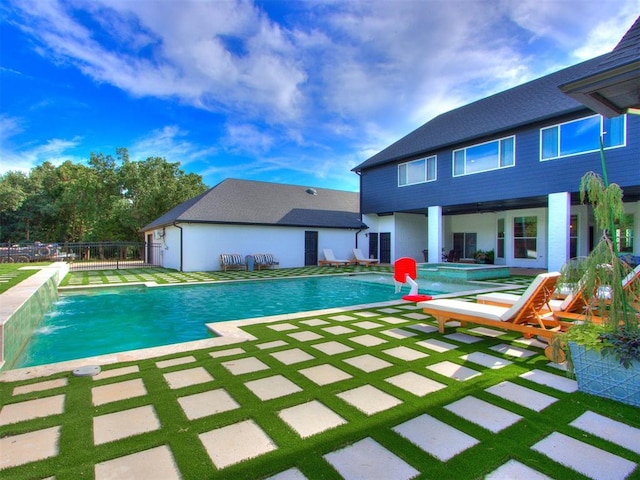 view of swimming pool featuring pool water feature and a patio