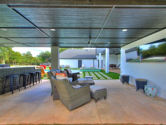 view of patio / terrace featuring a bar and ceiling fan