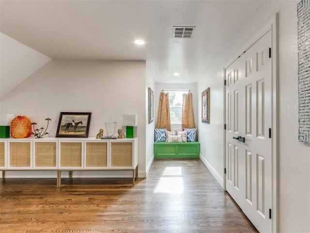 hallway with hardwood / wood-style flooring