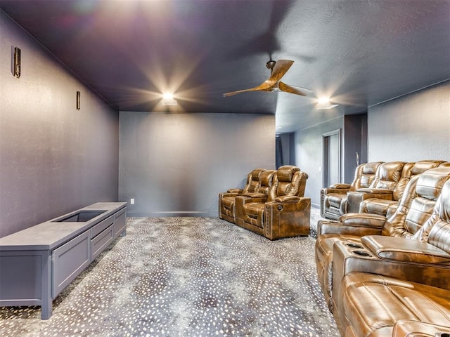 carpeted home theater with ceiling fan