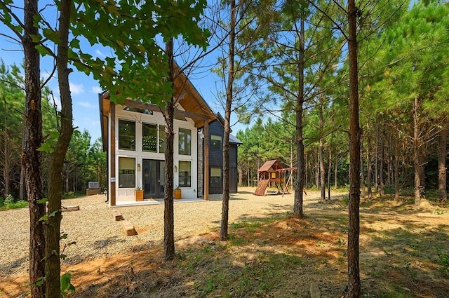 rear view of house with a playground