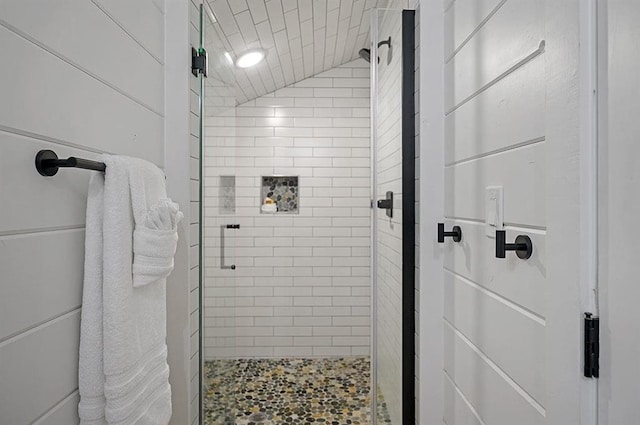 bathroom with lofted ceiling and walk in shower