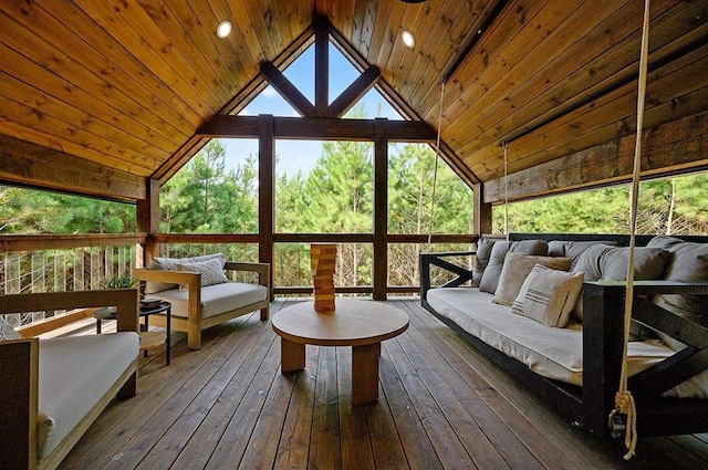 sunroom / solarium featuring lofted ceiling, wooden ceiling, and a healthy amount of sunlight