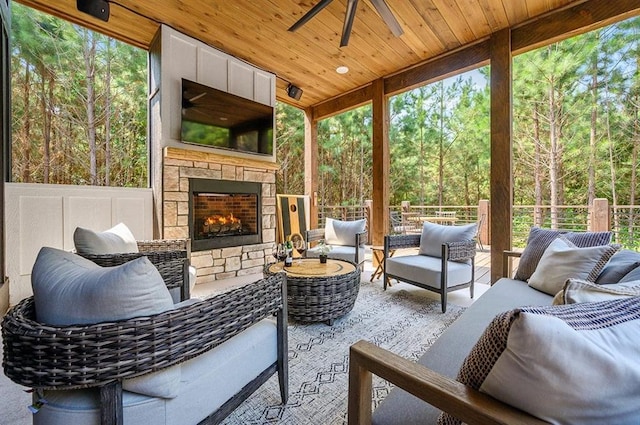 view of patio / terrace with an outdoor living space with a fireplace and ceiling fan