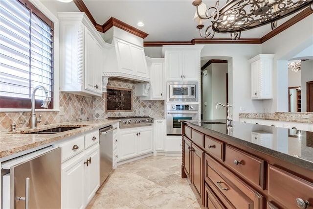 kitchen featuring appliances with stainless steel finishes, white cabinetry, dark stone counters, and sink