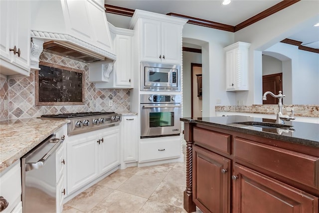 kitchen featuring white cabinetry, sink, appliances with stainless steel finishes, and ornamental molding