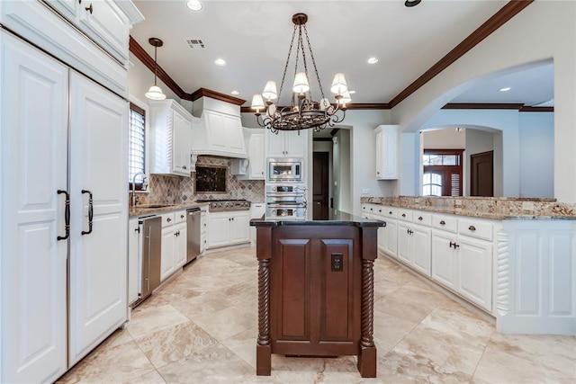 kitchen with white cabinets, custom range hood, stainless steel appliances, and a wealth of natural light