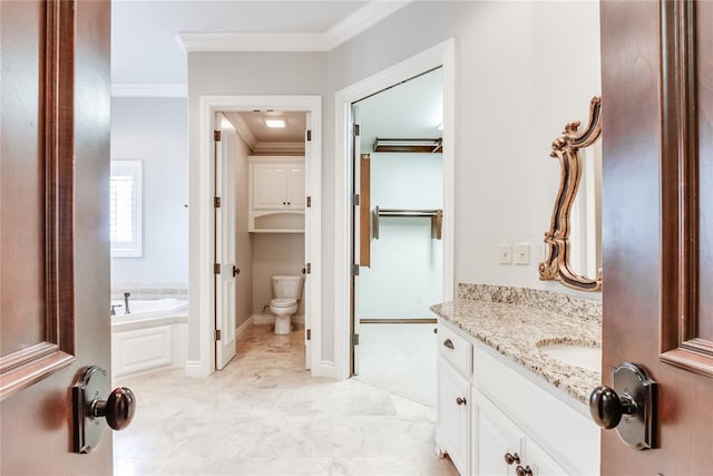 bathroom featuring vanity, toilet, ornamental molding, and a tub