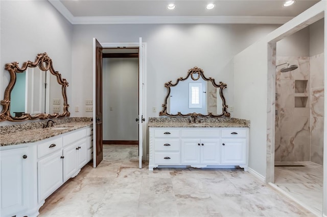 bathroom with vanity, a tile shower, and ornamental molding