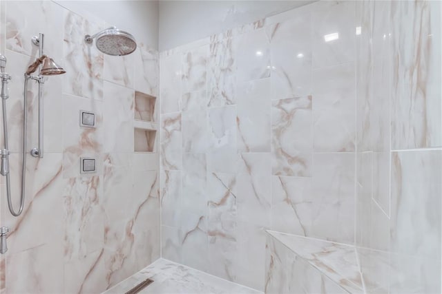 bathroom with a tile shower