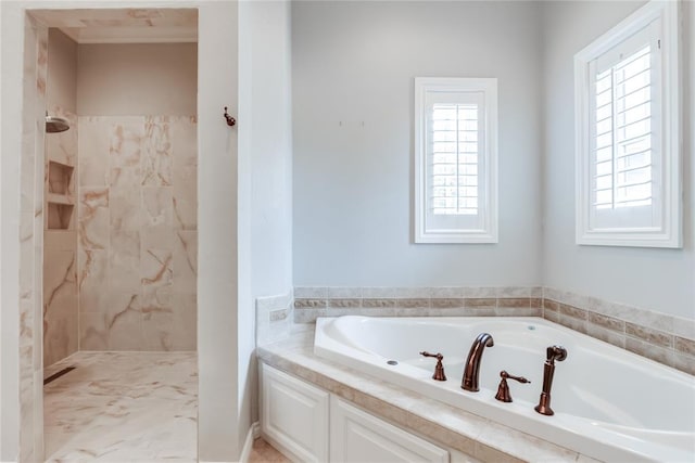 bathroom with shower with separate bathtub and a wealth of natural light