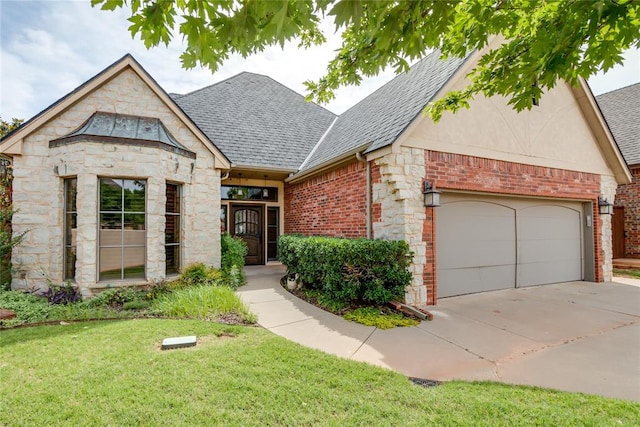 view of front of home with a front yard and a garage