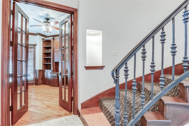 foyer with wood-type flooring and crown molding