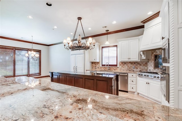 kitchen featuring decorative light fixtures, light stone counters, white cabinetry, and appliances with stainless steel finishes