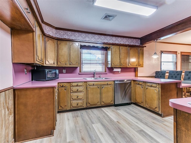 kitchen featuring a healthy amount of sunlight, sink, stainless steel dishwasher, and decorative light fixtures