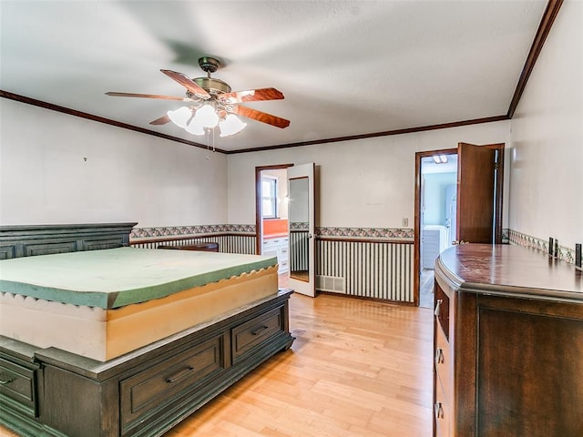 bedroom featuring ensuite bathroom, ceiling fan, light wood-type flooring, and ornamental molding