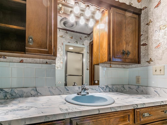 bathroom featuring vanity, tasteful backsplash, and crown molding