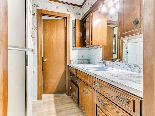 bathroom with vanity, an enclosed shower, wood-type flooring, and ornamental molding