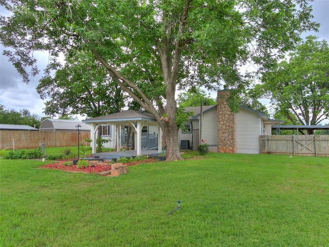 rear view of property featuring a lawn and covered porch