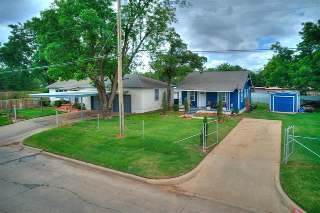 view of front of home with covered porch, an outbuilding, and a front lawn