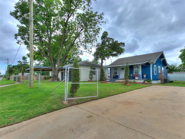 ranch-style house featuring covered porch and a front lawn