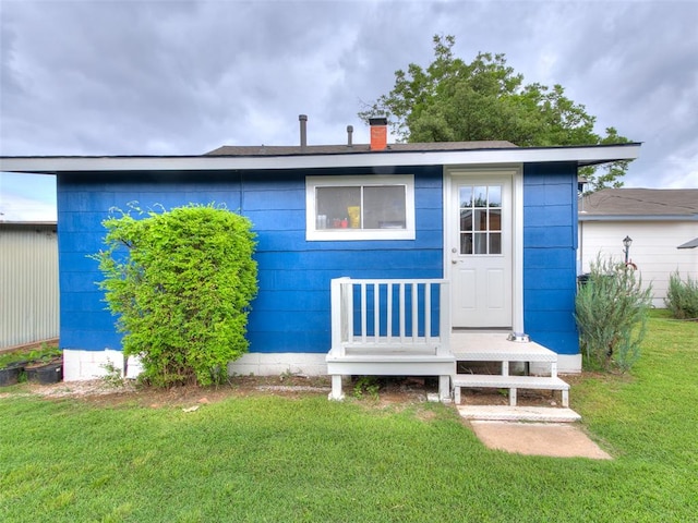 rear view of property with a yard