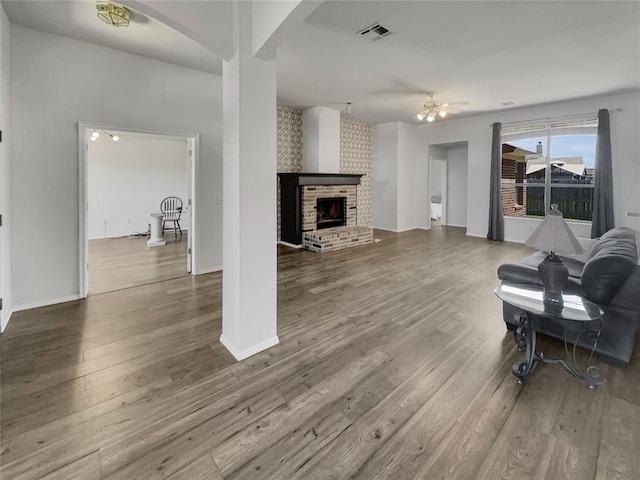 living room featuring hardwood / wood-style floors and a brick fireplace