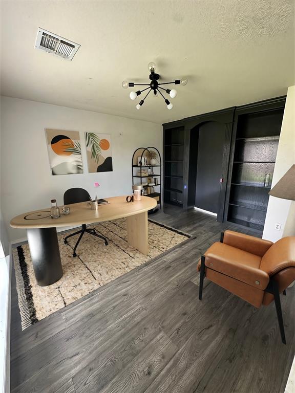 office featuring dark hardwood / wood-style flooring and a textured ceiling