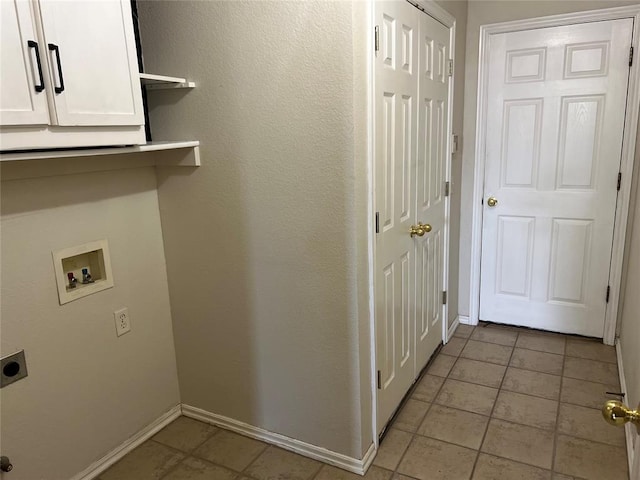 washroom featuring cabinets, light tile patterned flooring, washer hookup, and hookup for an electric dryer