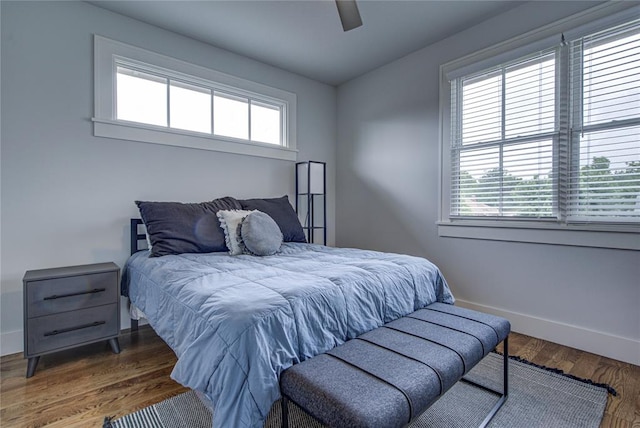 bedroom with ceiling fan and dark hardwood / wood-style flooring