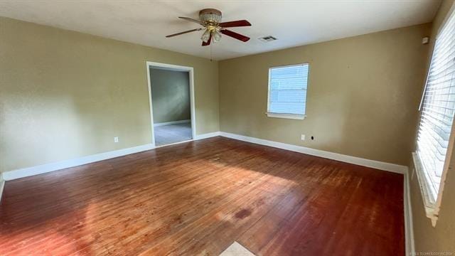 unfurnished room featuring hardwood / wood-style floors, plenty of natural light, and ceiling fan