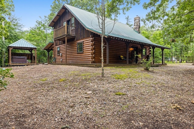 view of side of home featuring a hot tub