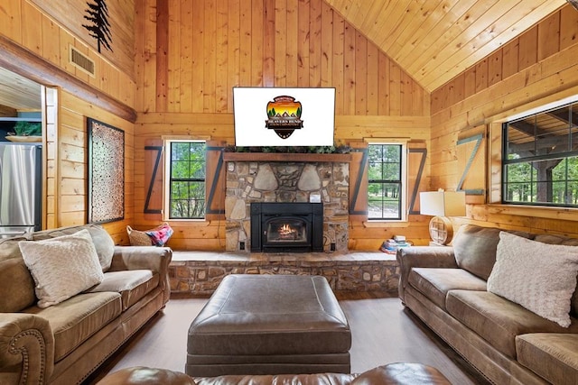 living room with high vaulted ceiling and wooden walls