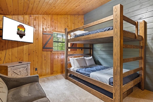 bedroom featuring carpet, vaulted ceiling, wooden walls, and wood ceiling