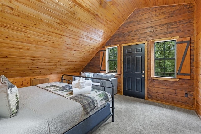 bedroom with carpet flooring, multiple windows, wooden walls, and lofted ceiling